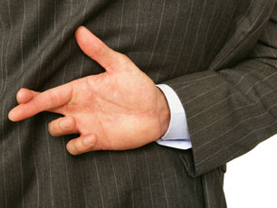 Fingers crossed behind a man's back (Image: Amanda Rohde/iStockphoto)