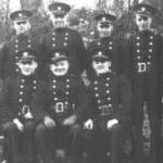 The firemen shown in the photograph are wearing the uniform of the National Fire Service. Charles Fredrick Taylor is shown standing third from the right.