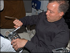 Astronaut cranks the can