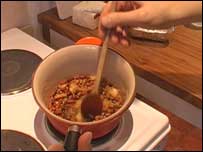 Pot on hob being stirred