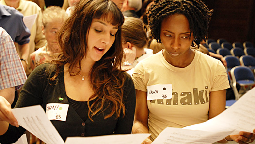 Two women studying lyrics at BBC Sing Live Events
