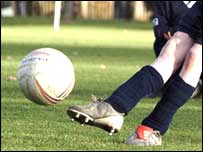 footballer kicking ball