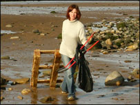 student cleaning up the beach