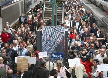 Fans leave a Eurostar fast train upon their arrival at Gare du Nord in paris