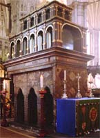 Edward's shrine in Westminster Abbey, a tall pillared box surrounded by candles