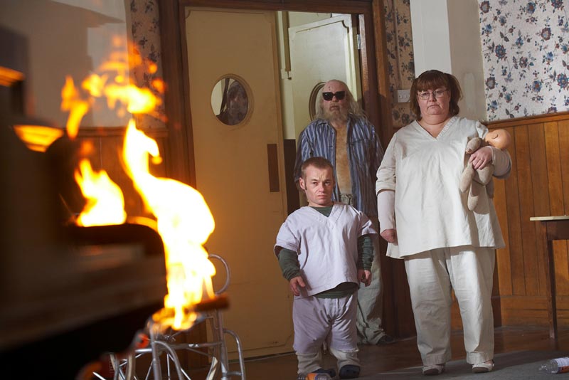 Robert, Joy and Lomax watch as fire starts.