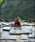 Boy sitting on a roof