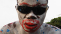 Accra man with face painted his party's colours