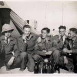 A merry group of mates Pete, Camp, Smudge, Ted, and Cliff in front of Jack Burgin’s tent on Christmas Day 1942.