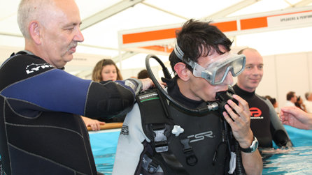 Gideon in the water, being shown how to scuba dive