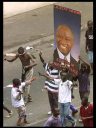Picture shows a UN soldier driving along a main road in an armed vehicle.