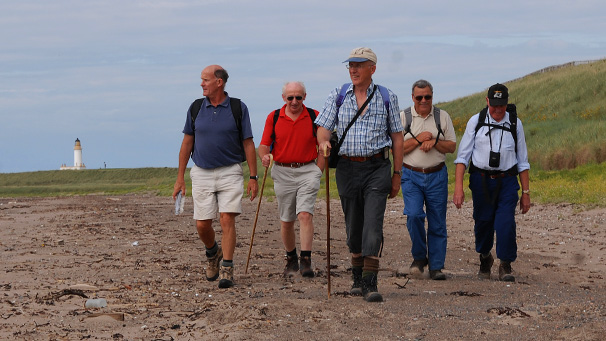 Rotary club members walking on the beach at Turnberry