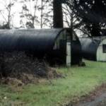 The last two surving Nissen Huts of Stanbury House Camp, Spencer's Wood, near Reading. Originally, Nissen Huts lined both sides of the long driveway beneath the large fir trees. This image was taken during a visit to Britain in 1964.