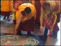 The sand is carefully brushed to the centre