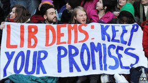 A group of students stage a protest at the London constituency office of Simon Hughes, the deputy leader of the Liberal Democrat party.