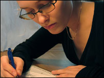 Someone writing with a pen