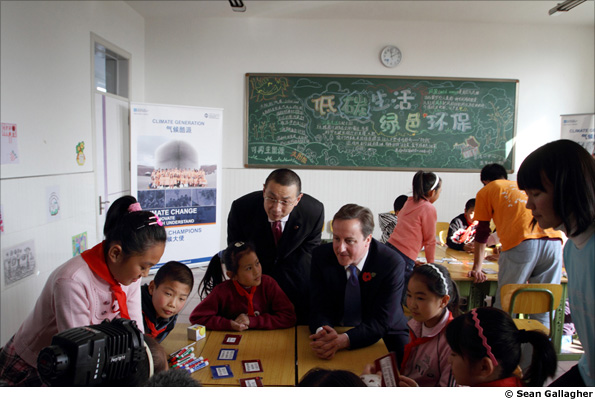 British Prime Minister David Cameron talks to local scheoolchildren in Beijing