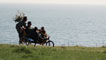 The four main characters on the cliff top with the sea in the background