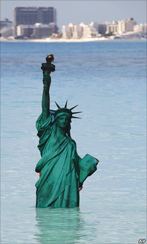 Climate protest at Cancun summit showing Statue of Liberty underwater
