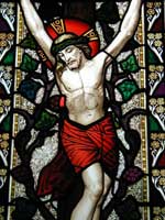 Jesus on the cross, shown on a stained glass window