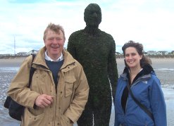 Dylan Winter, Dr Leonie Robinson and the Barnacle covered iron cast of Antony Gormley. (C) BBC.