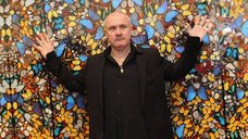 Damien Hirst in front of his Doorways to the Kingdom of Heaven artwork