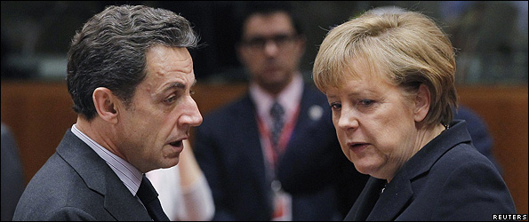 French President Nicolas Sarkozy talks to German Chancellor Angela Merkel