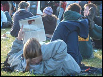 Reading the Sunday papers at Leeds Festival 2005