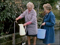 Residents collecting water from a standpipe