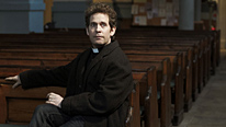 Reverend Adam Smallbone (Tom Hollander) has a crisis of faith