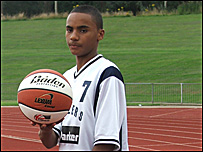Rema poses with basketball