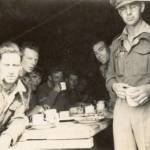 Christmas Dinner's were traditionally served by the Officers. Here dinner is being served by Captain Rice. Dinner was bully beef and boiled potatoes plus a glass of whiskey as a treat from the Captain.
