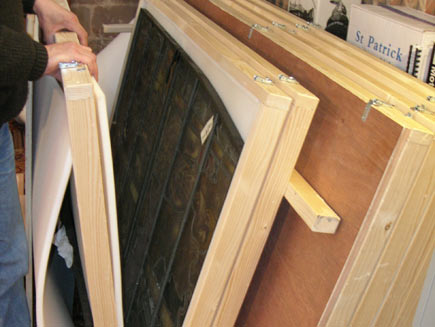 Each panel is carefully placed inside a wooden carton