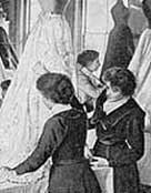 Two Victorian woman working on the stitch work of a womans dress