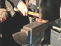 Meat clever being turned into flower on anvil