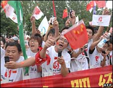 People cheer during the Olympic torch relay in Hefei, central China on 28 May 2008