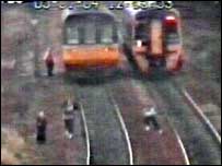 Children running along tracks with an approaching train