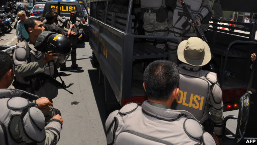 Police reinforcements arrive outside the Kerobokan prison in Denpasar in Indonesia"s resort island of Bali on the second day of rioting February 23, 2012