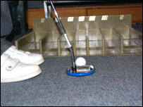 A man putting a golf ball.