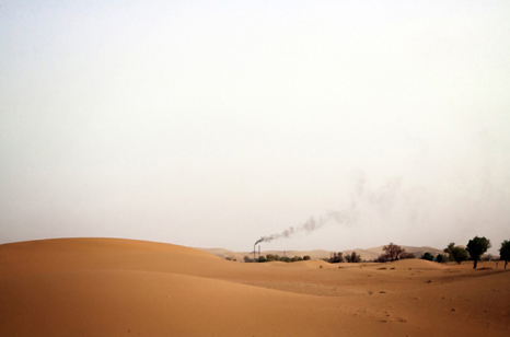 A lone factory surrounded by sand dunes in Inner Mongolia. 2009