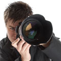 A paparazzi photographer obscured by his camera