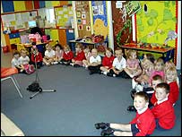 All the children from the nursery sitting in a horseshoe