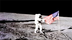 Apollo 12 astronaut Charles 'Pete' Conrad stands beside the United States flag. Image (c) NASA