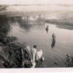 Native women in a jungle pool washing and bathing.