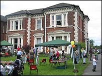 Women's refuge building with party in foreground