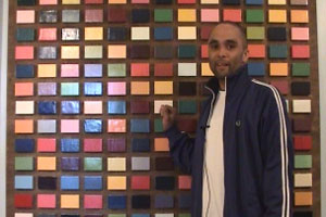 Tom shows off a piece of art he owns, after having won it playing pool