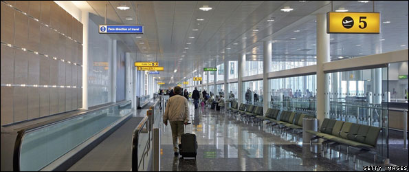 Passengers walking through Heathrow airport