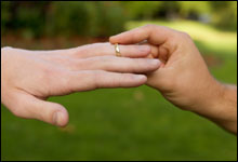 Man placing ring on finger
