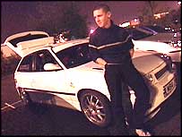 Boy sitting on a car