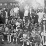 A concert audience in the garden, Rotherham 1940's. Audrey holds her baby sister.(On the right)